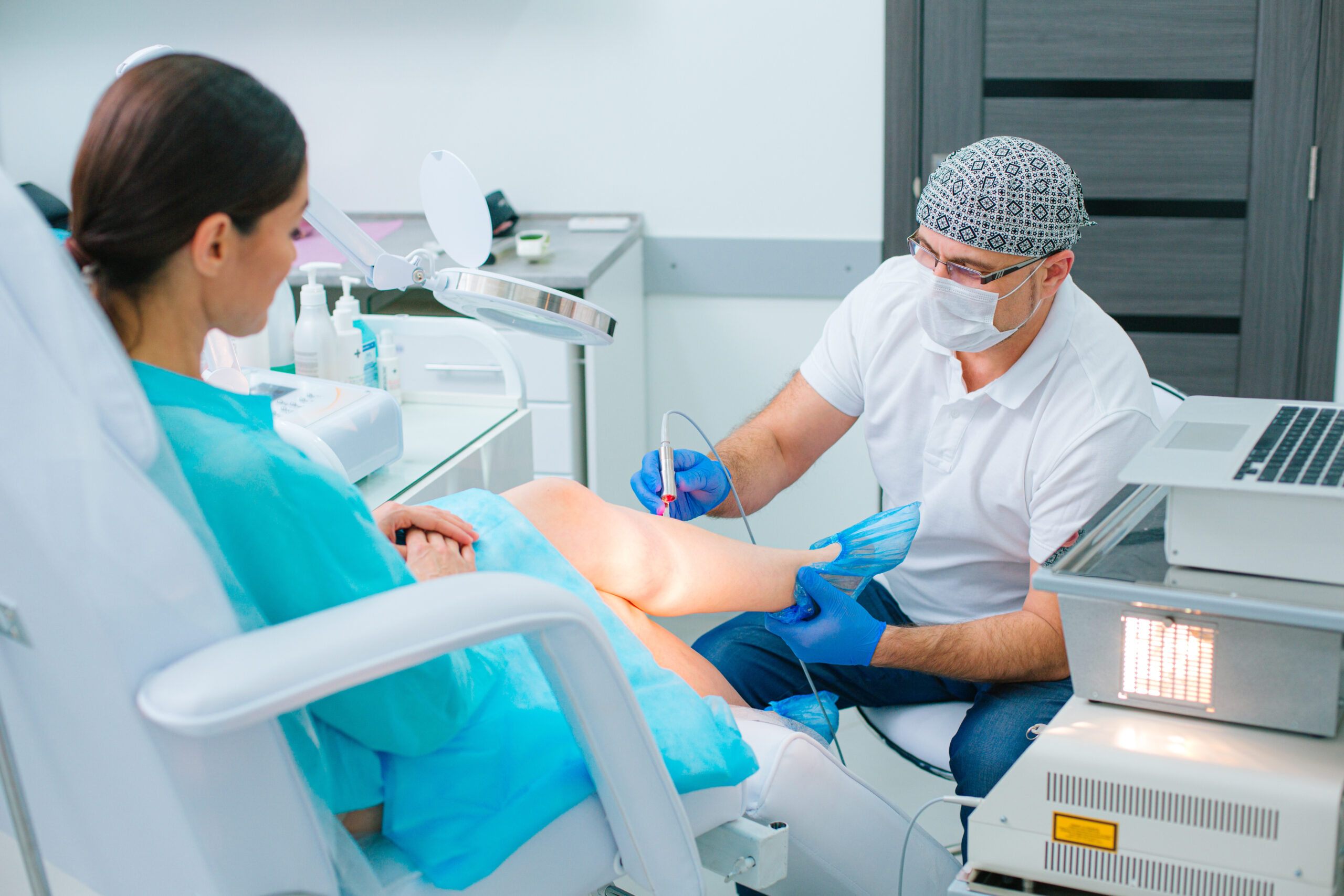 A doctor using laser to do vein removal