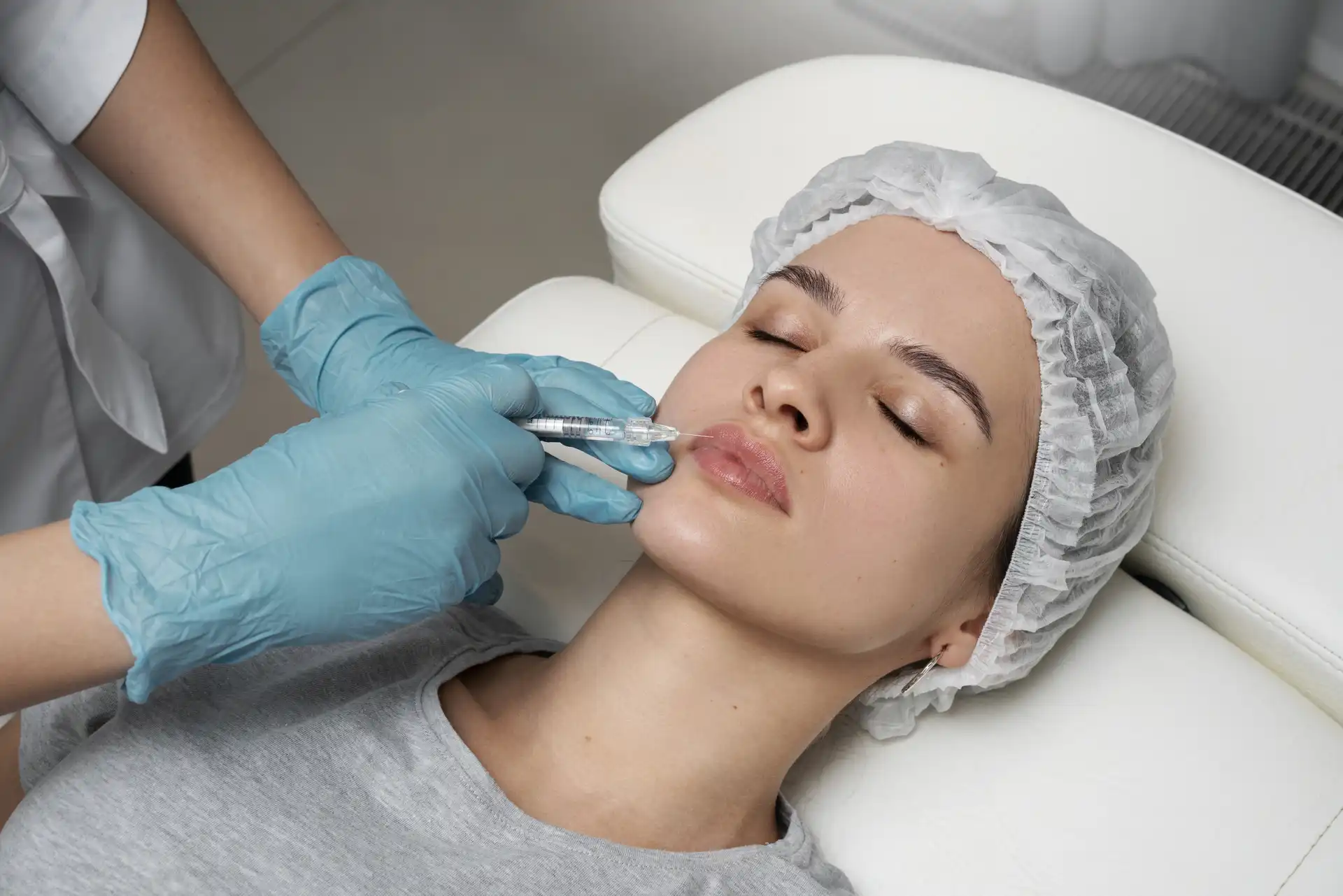 Woman receiving cosmetic injectable treatment for Botox, dermal fillers, PRP, and aesthetic rejuvenation at Elegance Cosmetic Clinic