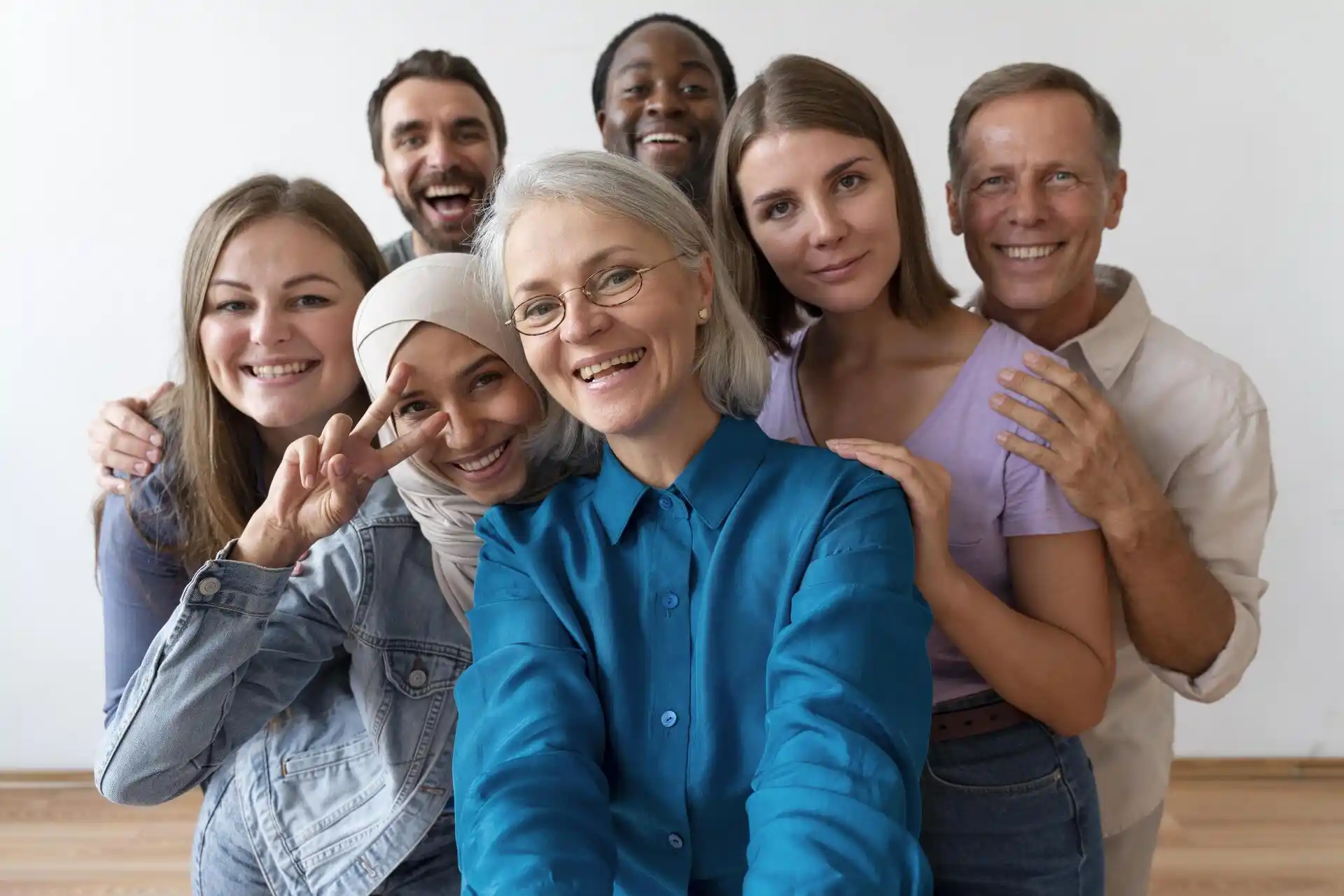 Diverse group of smiling adults in their 20s to 60s taking a selfie after skin rejuvenation in Thornhill clinic