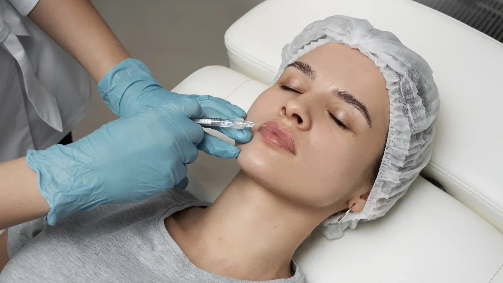 Woman receiving cosmetic injectable treatment for Botox, dermal fillers, PRP, and aesthetic rejuvenation at Elegance Cosmetic Clinic