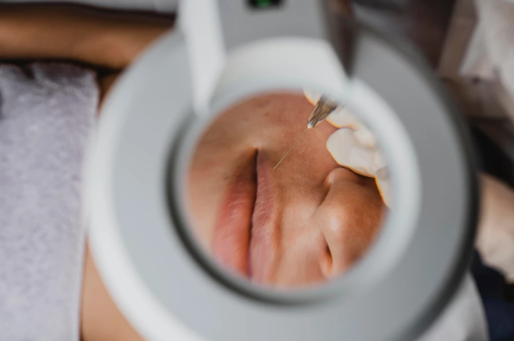 Aesthetician examining skin before a facial treatment